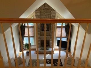 stairs with a fireplace and a healthy amount of sunlight