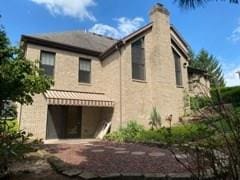 back of property with a patio