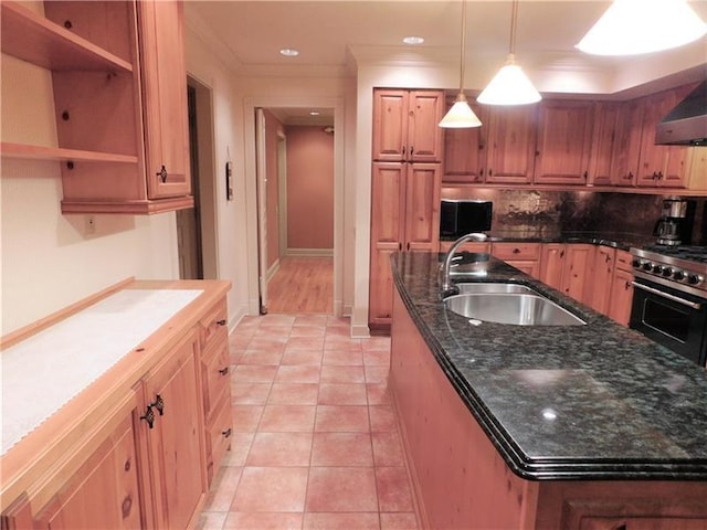 kitchen with hanging light fixtures, sink, stainless steel range, light tile floors, and tasteful backsplash