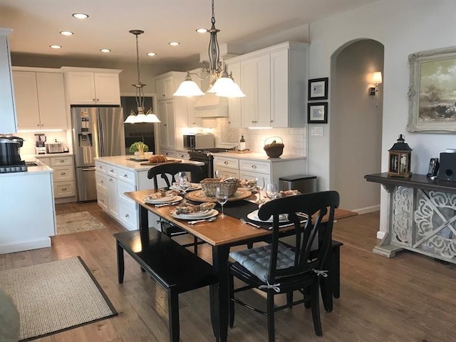 dining area with a chandelier and light wood-type flooring