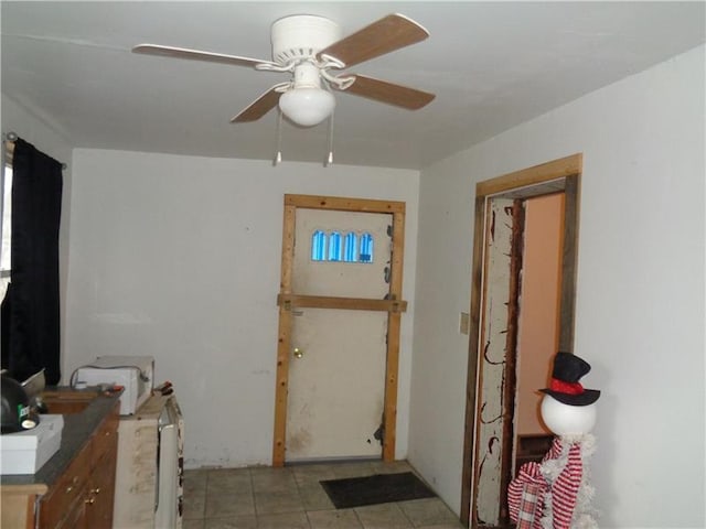 interior space with ceiling fan