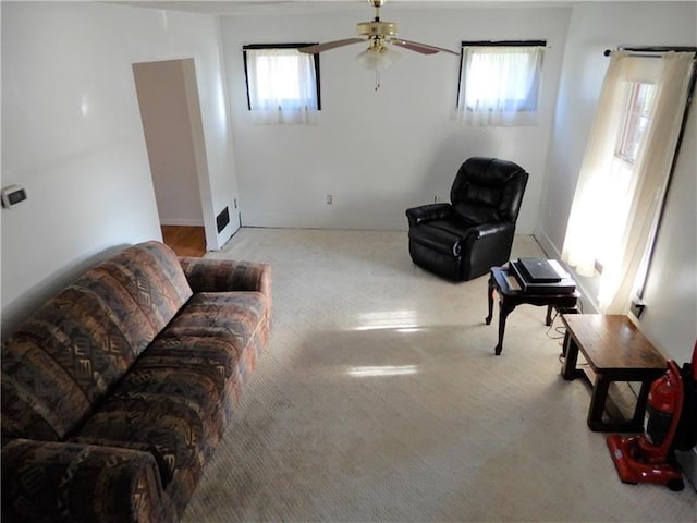 interior space with light carpet and ceiling fan