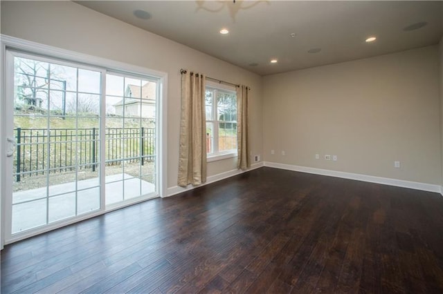 spare room with dark wood-type flooring