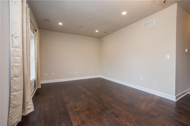 unfurnished room with dark hardwood / wood-style flooring