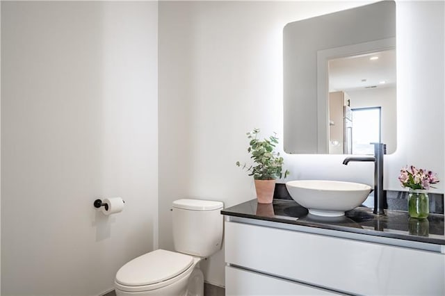 bathroom with toilet and oversized vanity