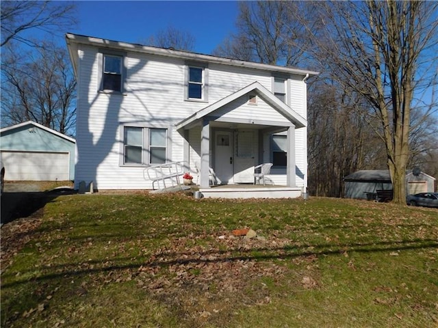 view of front of house with covered porch, a front lawn, and a garage