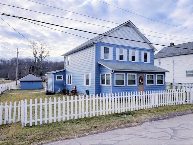 front of property with a front lawn and a garage