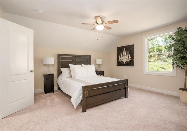 bedroom featuring ceiling fan, light colored carpet, and vaulted ceiling