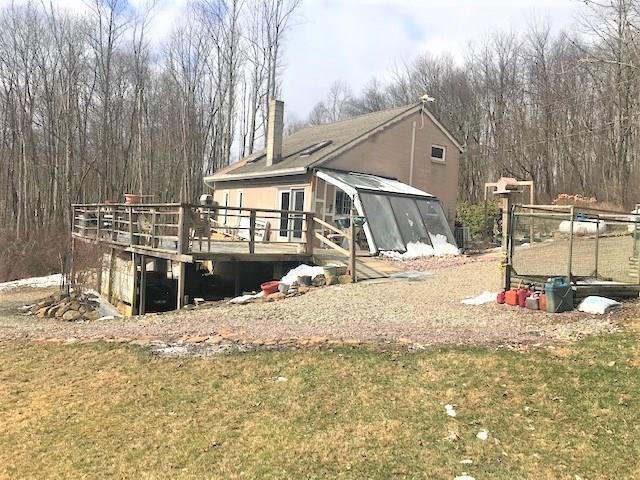 rear view of house with a wooden deck