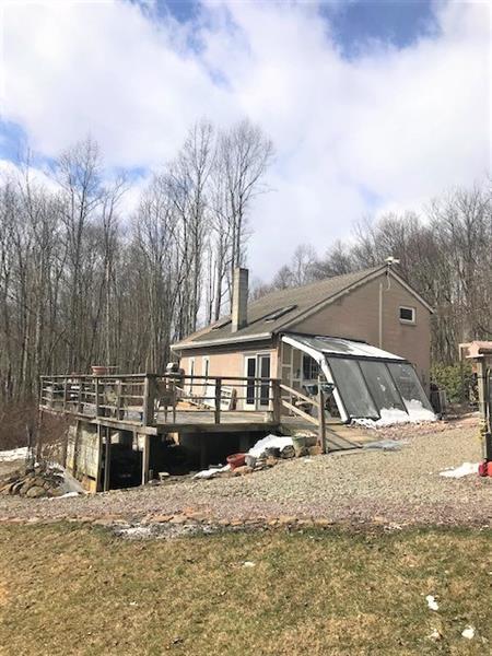 rear view of property with a wooden deck