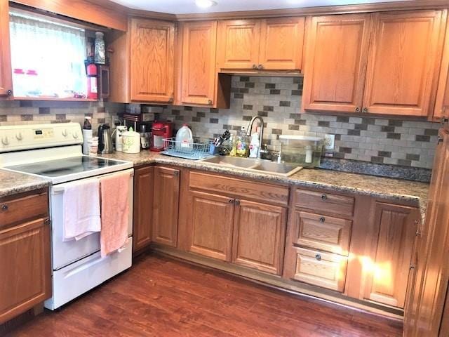 kitchen with tasteful backsplash, white electric range oven, dark hardwood / wood-style floors, and sink