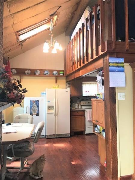 kitchen featuring dark hardwood / wood-style flooring, range, white fridge with ice dispenser, tasteful backsplash, and a notable chandelier