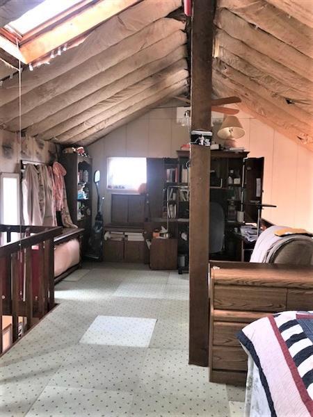 interior space with lofted ceiling with skylight and light colored carpet