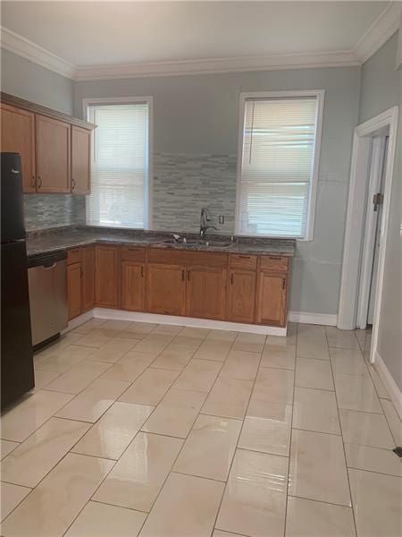 kitchen with black fridge, stainless steel dishwasher, tasteful backsplash, and light tile flooring