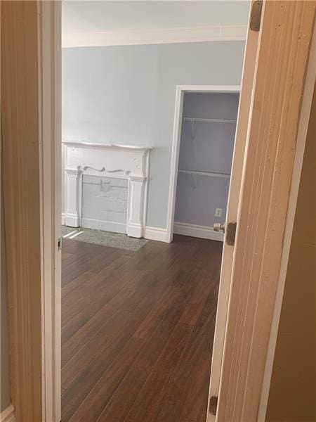 corridor with dark hardwood / wood-style flooring