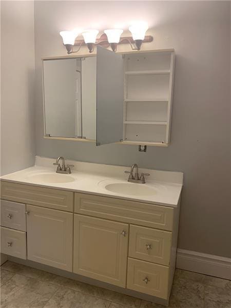 bathroom featuring double vanity and tile floors