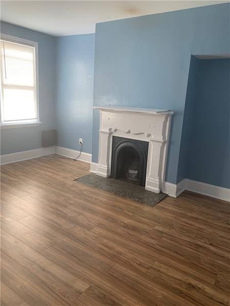 unfurnished living room featuring hardwood / wood-style flooring