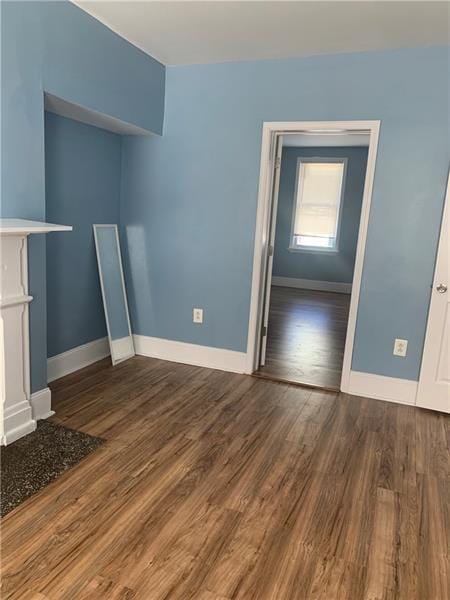 unfurnished living room with dark hardwood / wood-style floors