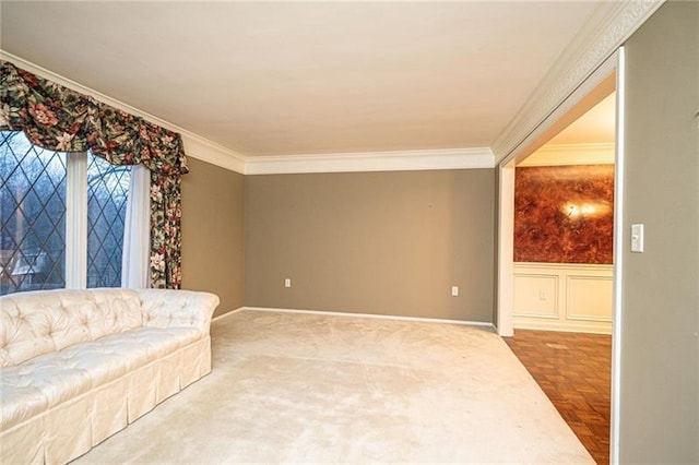 sitting room featuring ornamental molding and carpet floors