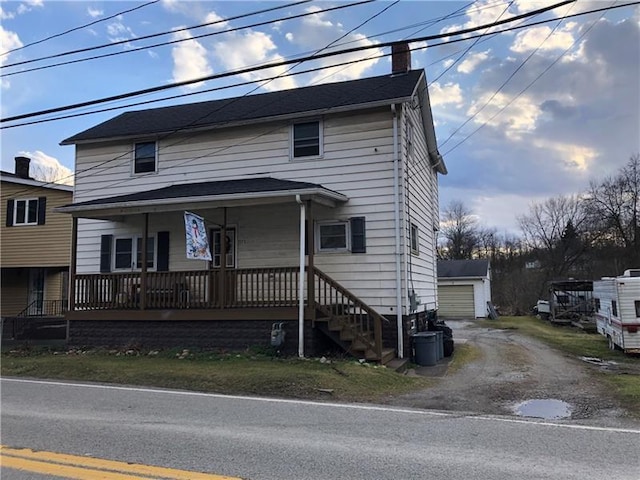 view of front of home featuring covered porch and a garage