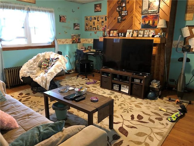 living room featuring radiator heating unit and light hardwood / wood-style flooring