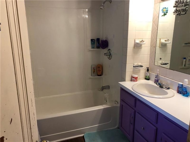 bathroom featuring vanity and tiled shower / bath