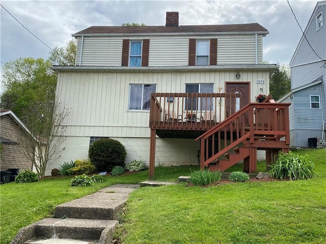 back of house with a wooden deck and a yard