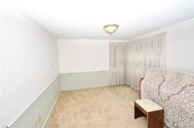 sitting room featuring crown molding and light colored carpet