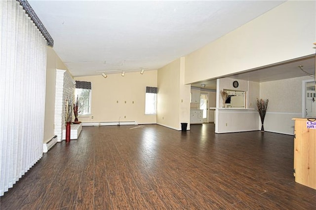 unfurnished living room with track lighting, a baseboard radiator, and dark hardwood / wood-style floors