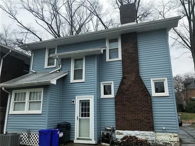 rear view of property featuring central AC