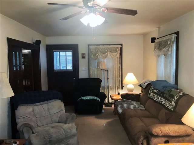 living room featuring ceiling fan and carpet