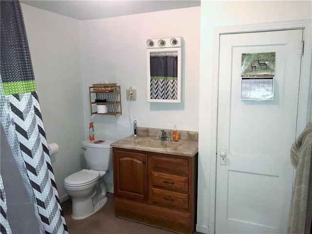 bathroom featuring oversized vanity and toilet