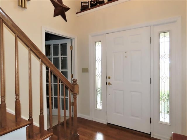 entryway featuring plenty of natural light and dark hardwood / wood-style floors