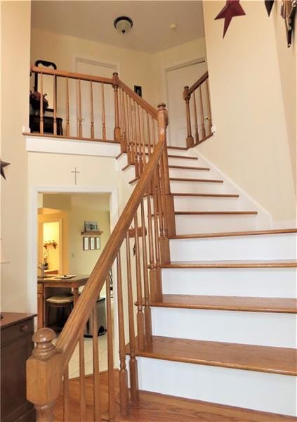 stairway with hardwood / wood-style floors