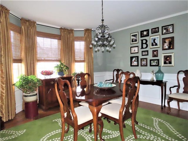 dining room with an inviting chandelier, dark hardwood / wood-style floors, a wealth of natural light, and ornamental molding