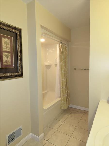 bathroom featuring tile flooring and shower / bath combo