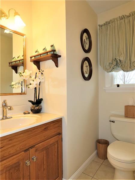 bathroom with toilet, tile flooring, and vanity