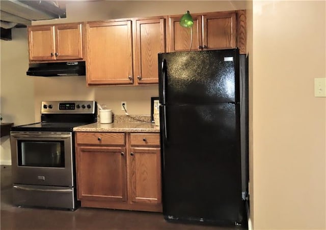 kitchen featuring stainless steel range with electric stovetop and black refrigerator