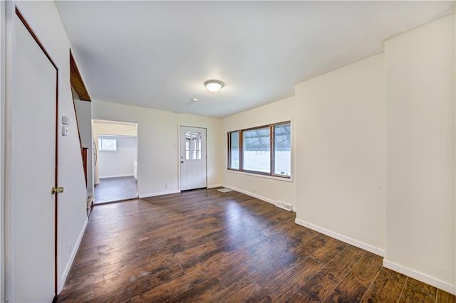 empty room with dark hardwood / wood-style flooring