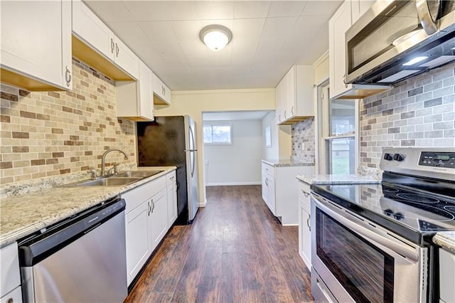 kitchen featuring dark hardwood / wood-style flooring, tasteful backsplash, white cabinetry, stainless steel appliances, and sink