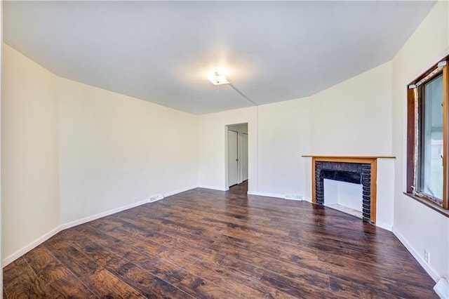 unfurnished living room featuring dark hardwood / wood-style floors and a fireplace