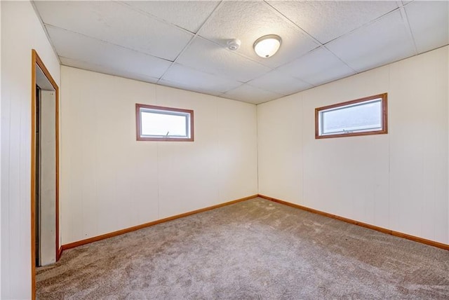 empty room featuring carpet flooring and a drop ceiling