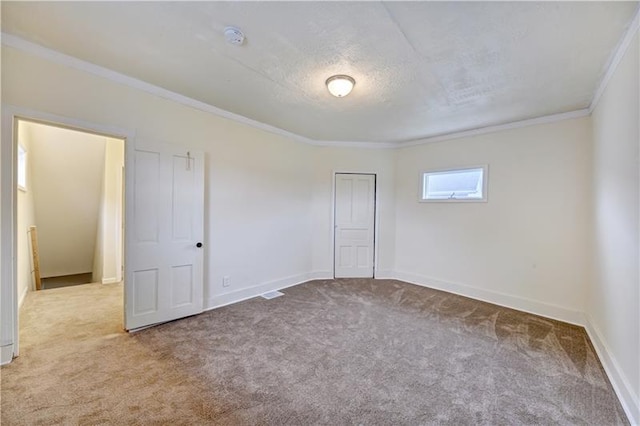 unfurnished bedroom with ornamental molding and light carpet