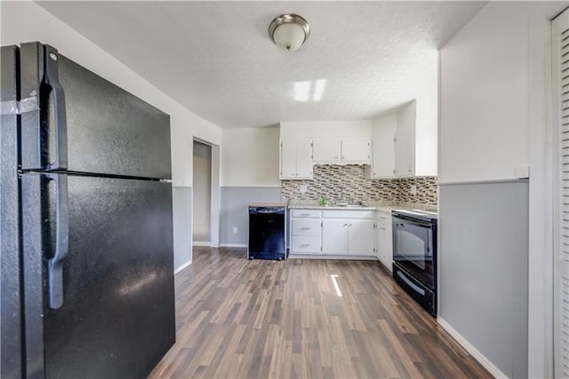 kitchen featuring a textured ceiling, tasteful backsplash, black appliances, white cabinets, and dark hardwood / wood-style floors