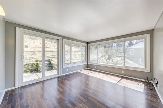 unfurnished room with dark wood-type flooring