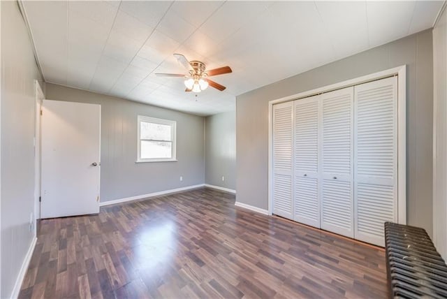 unfurnished bedroom featuring ceiling fan, a closet, and dark hardwood / wood-style floors