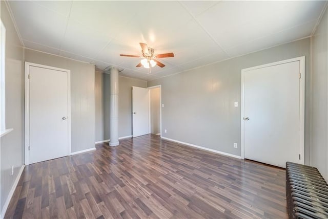 empty room featuring ceiling fan and dark wood-type flooring