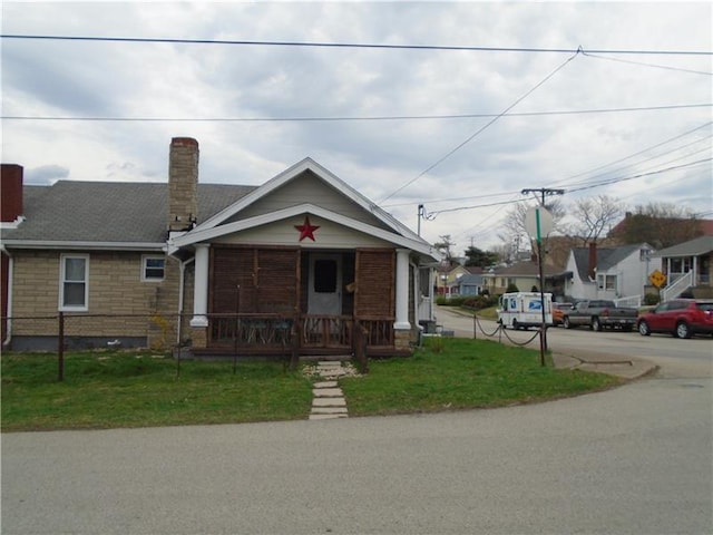 bungalow-style house featuring a porch and a front yard