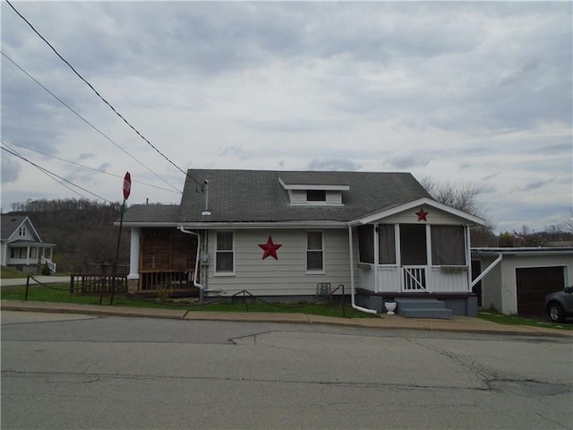 view of front of house featuring a garage and a sunroom