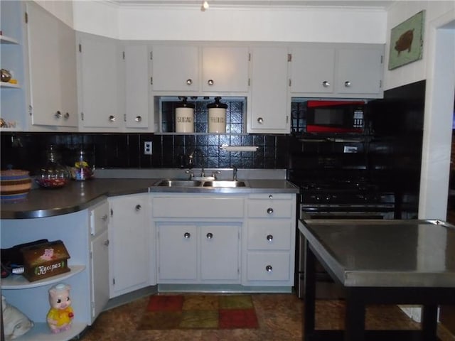 kitchen with white cabinets, backsplash, range, and sink